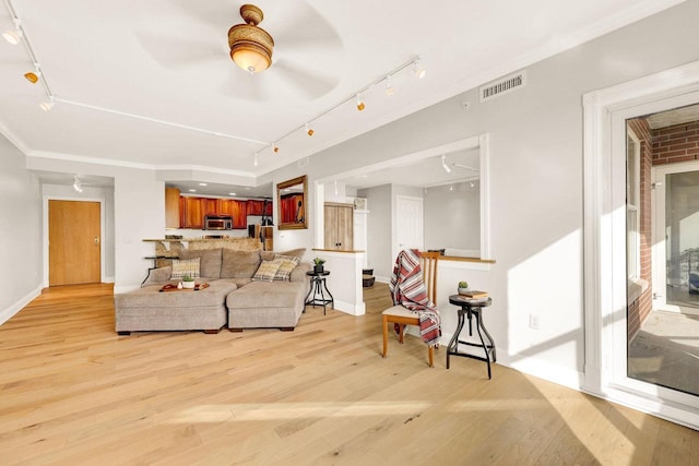 living room with ceiling fan, light hardwood / wood-style flooring, and ornamental molding