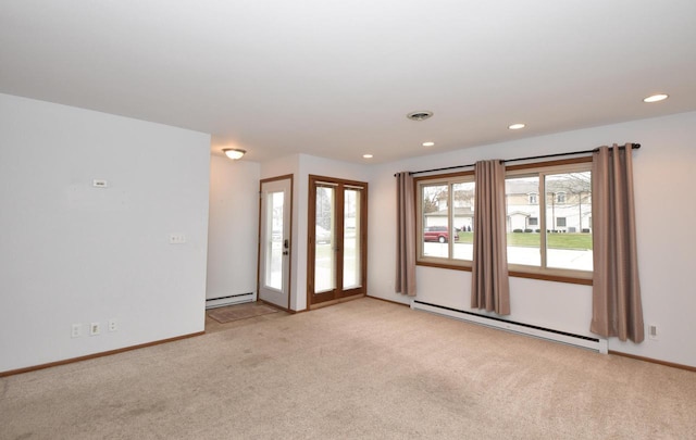 empty room with a baseboard radiator and light colored carpet