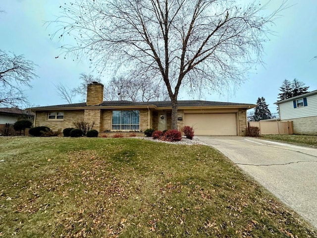 ranch-style house featuring a front yard and a garage