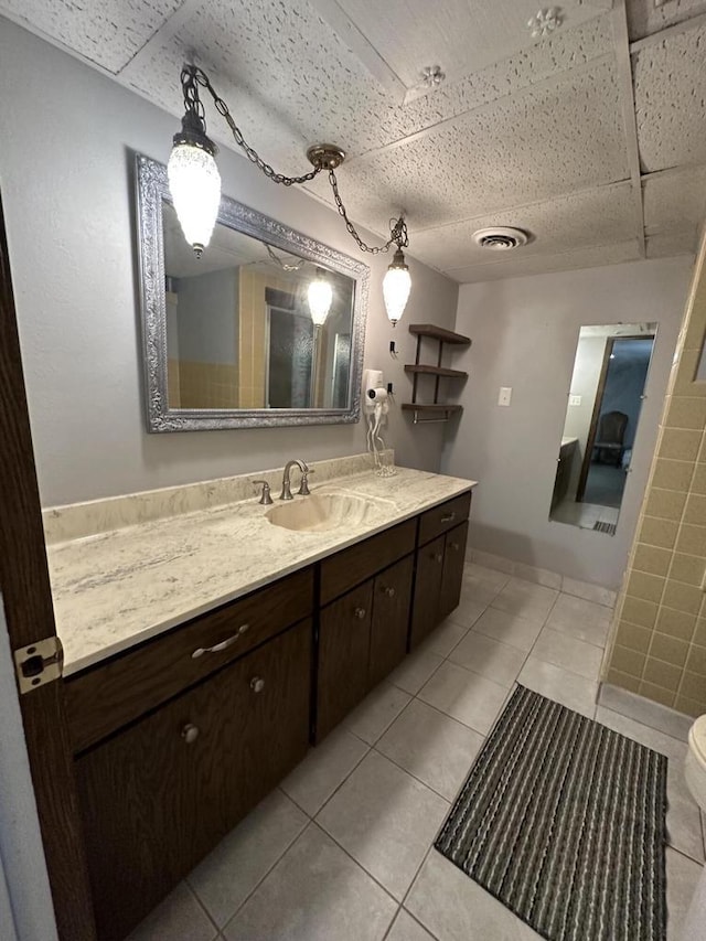 bathroom featuring tile patterned flooring and vanity