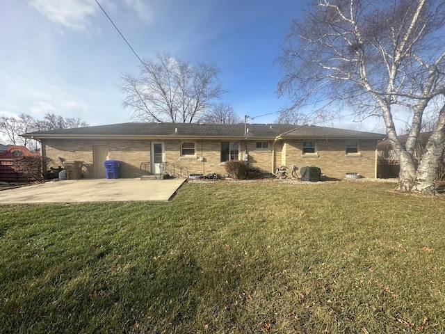 back of property featuring a yard and a patio