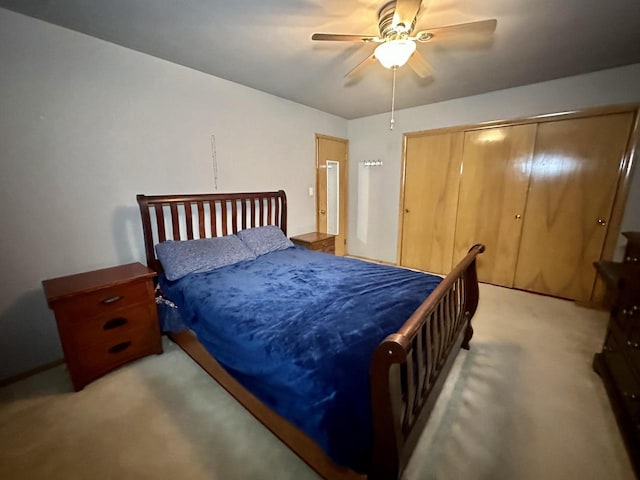 carpeted bedroom with ceiling fan and a closet