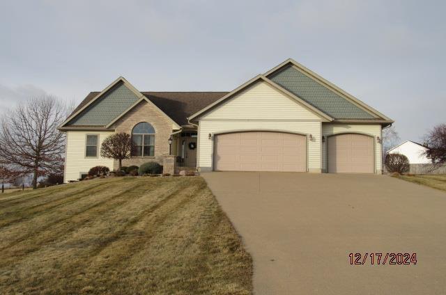 ranch-style house with a front lawn and a garage