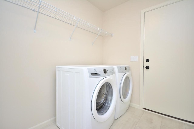 washroom featuring independent washer and dryer and light tile patterned floors