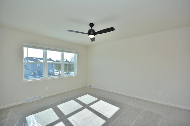 spare room featuring ceiling fan and carpet floors