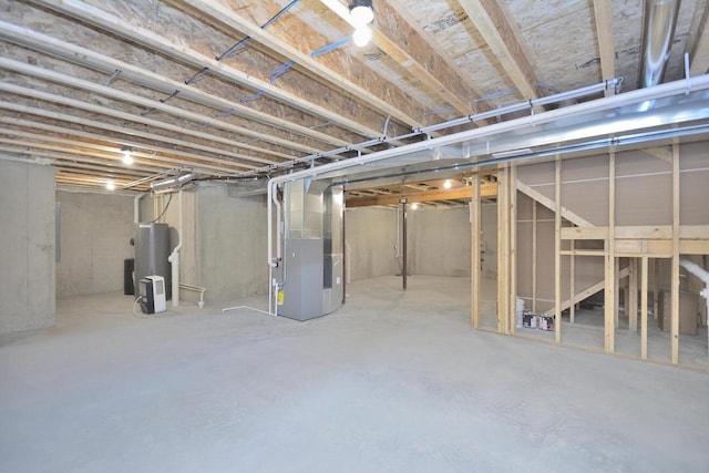 basement with electric water heater and heating unit