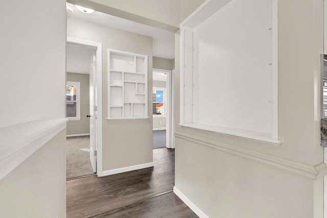 corridor with dark hardwood / wood-style floors