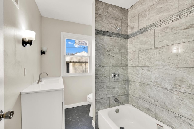 full bathroom featuring tile patterned flooring, vanity, toilet, and tiled shower / bath combo