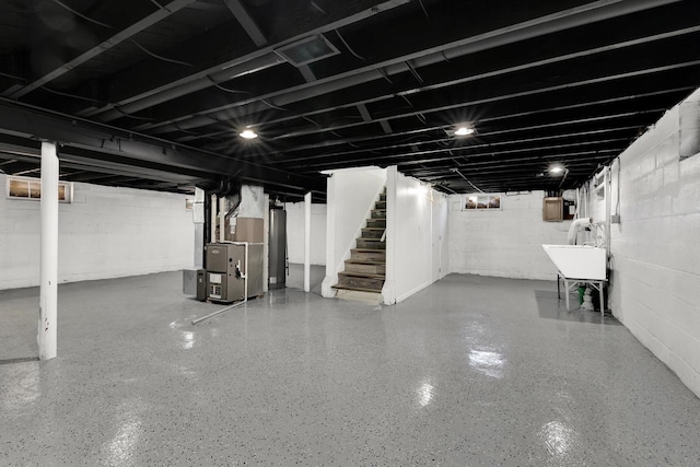 basement featuring heating unit and sink