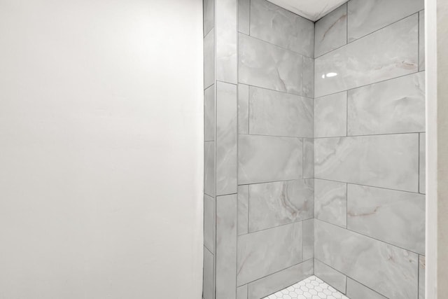 bathroom with tiled shower