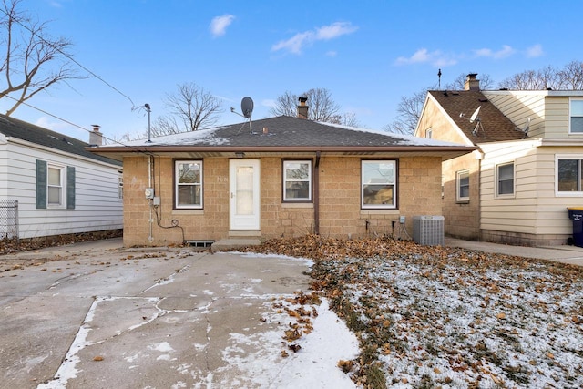 snow covered property with central air condition unit