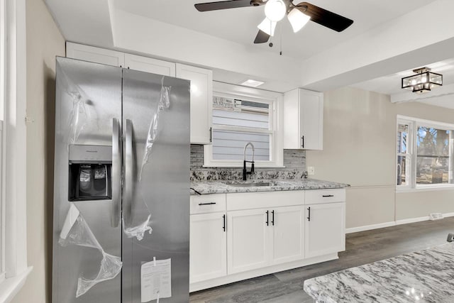 kitchen with sink, white cabinets, dark wood-type flooring, and stainless steel refrigerator with ice dispenser