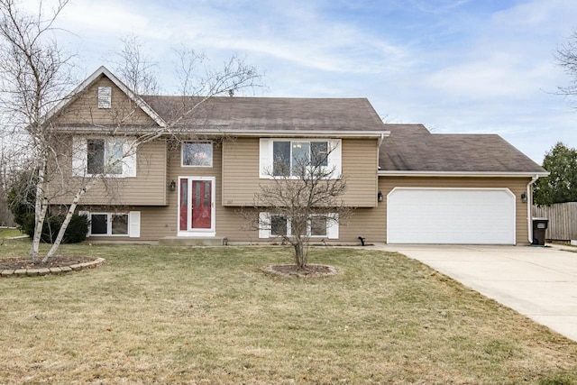 split foyer home with a front yard and a garage