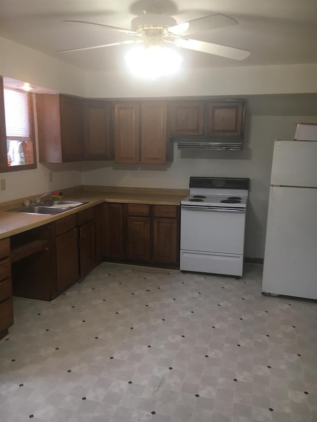 kitchen featuring ceiling fan, sink, and white appliances