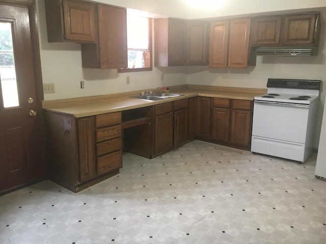 kitchen featuring white electric stove, plenty of natural light, and sink