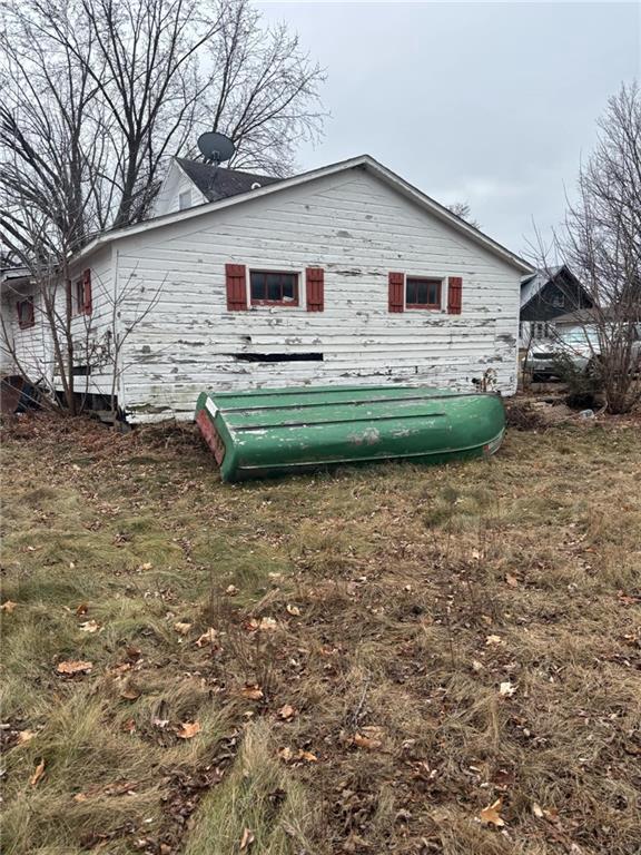 view of side of home featuring a yard