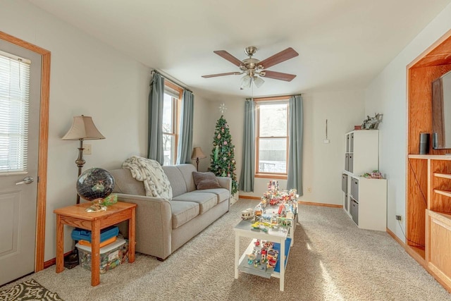 living room featuring ceiling fan and light colored carpet