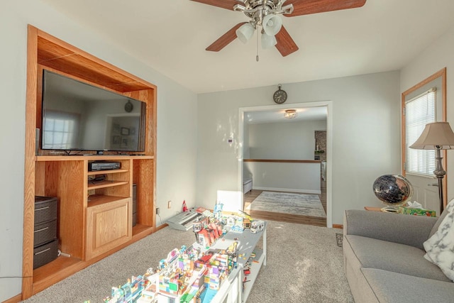 carpeted living room featuring ceiling fan