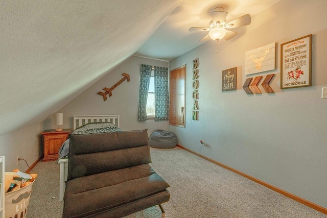 carpeted bedroom featuring vaulted ceiling, ceiling fan, and a textured ceiling