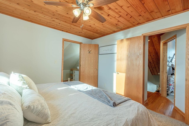 bedroom with ceiling fan, ornamental molding, wooden ceiling, and wood-type flooring