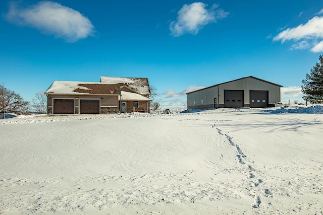 yard layered in snow with a garage