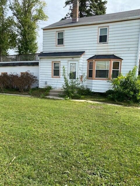 rear view of house with a lawn