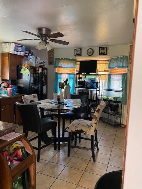 dining area featuring ceiling fan and light tile patterned flooring