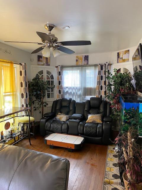 living room with hardwood / wood-style floors and ceiling fan