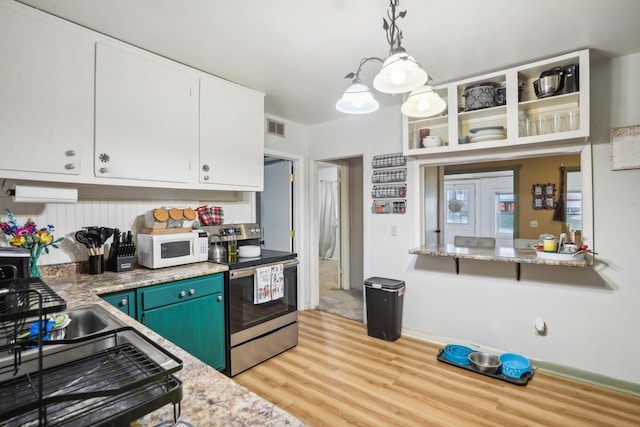 kitchen with hanging light fixtures, blue cabinets, stainless steel range with electric cooktop, light hardwood / wood-style floors, and white cabinets