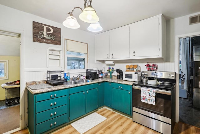 kitchen with white cabinetry, electric range, sink, hanging light fixtures, and light hardwood / wood-style floors