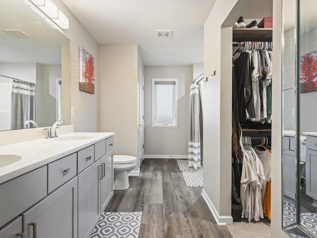 bathroom with hardwood / wood-style floors, vanity, toilet, and a shower with shower curtain