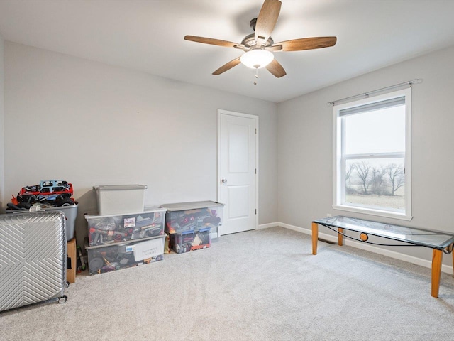 misc room with light carpet and ceiling fan