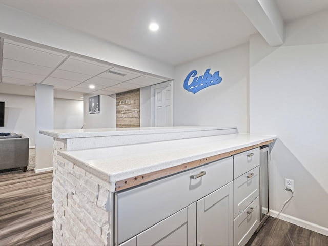 kitchen with dark hardwood / wood-style floors and kitchen peninsula