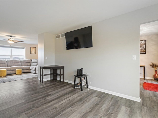 living room featuring dark hardwood / wood-style floors and ceiling fan