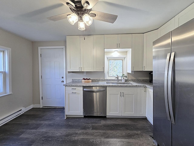 kitchen featuring sink, a baseboard radiator, dark hardwood / wood-style flooring, white cabinetry, and stainless steel appliances