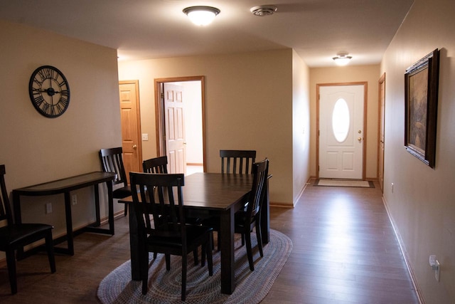 dining area with dark hardwood / wood-style flooring