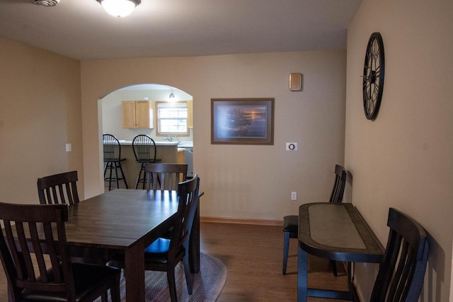 dining space with dark hardwood / wood-style floors