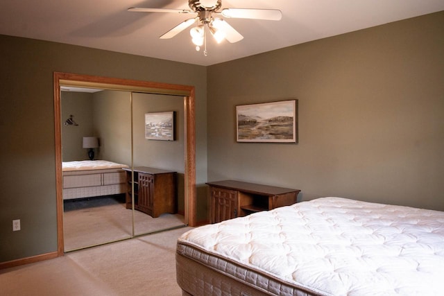 bedroom featuring light carpet, a closet, and ceiling fan