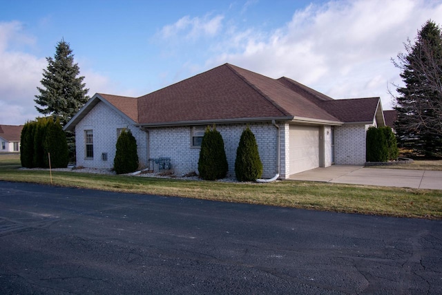 view of front of home with a front yard and a garage