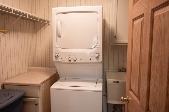 laundry room with stacked washer / drying machine