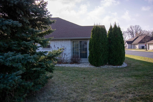 view of property exterior with a yard