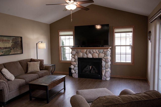 living room featuring ceiling fan, a stone fireplace, dark hardwood / wood-style flooring, and lofted ceiling