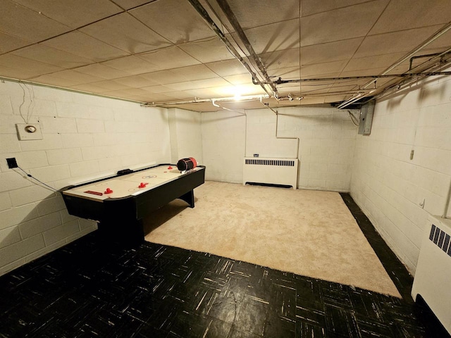 playroom with dark colored carpet and radiator heating unit