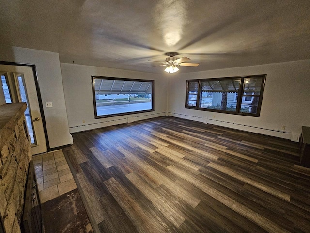 interior space with a textured ceiling, dark hardwood / wood-style flooring, and ceiling fan