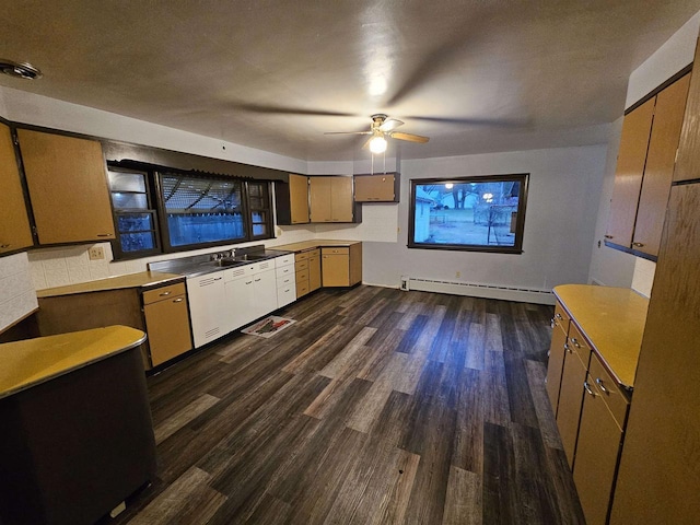 kitchen with a baseboard radiator, ceiling fan, dark wood-type flooring, and sink