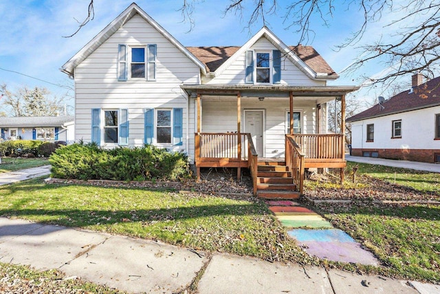 bungalow-style house featuring covered porch and a front yard