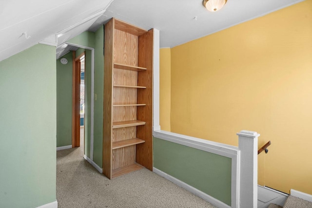 interior space featuring light colored carpet and vaulted ceiling