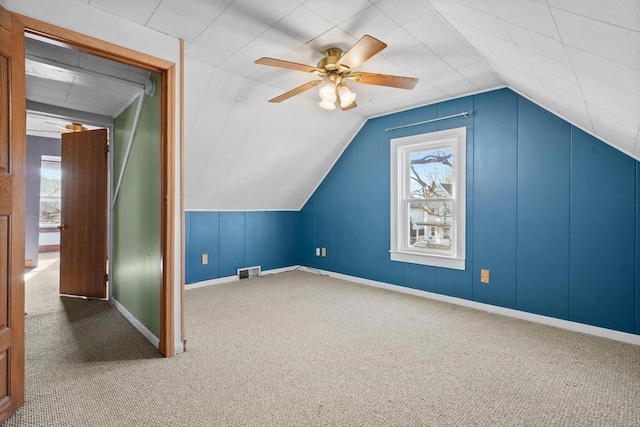 additional living space with ceiling fan, carpet floors, and vaulted ceiling