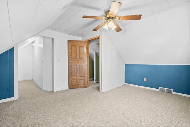 bonus room with carpet flooring, vaulted ceiling, and ceiling fan