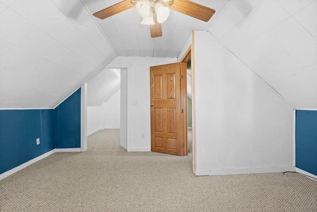 additional living space featuring carpet, vaulted ceiling, and ceiling fan